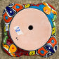 Hand painted Mexican Talavera Strawberry pot with a large top opening a four pockets on each side.  Trim color is turquoise body has multi-color designs. Bottom view showing drain hole.