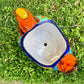 Colorful orange multi-color Mexican Talavera ceramic chicken shape planter on a natural background Top opening