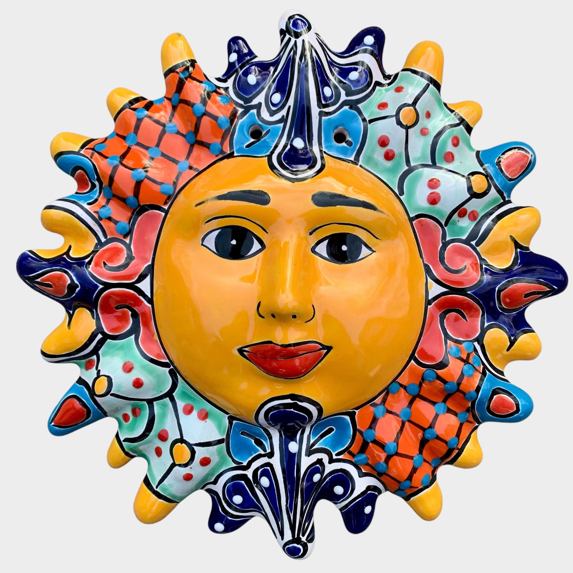 Decorative Talavera sun-shaped wall art with colorful face design on a white background