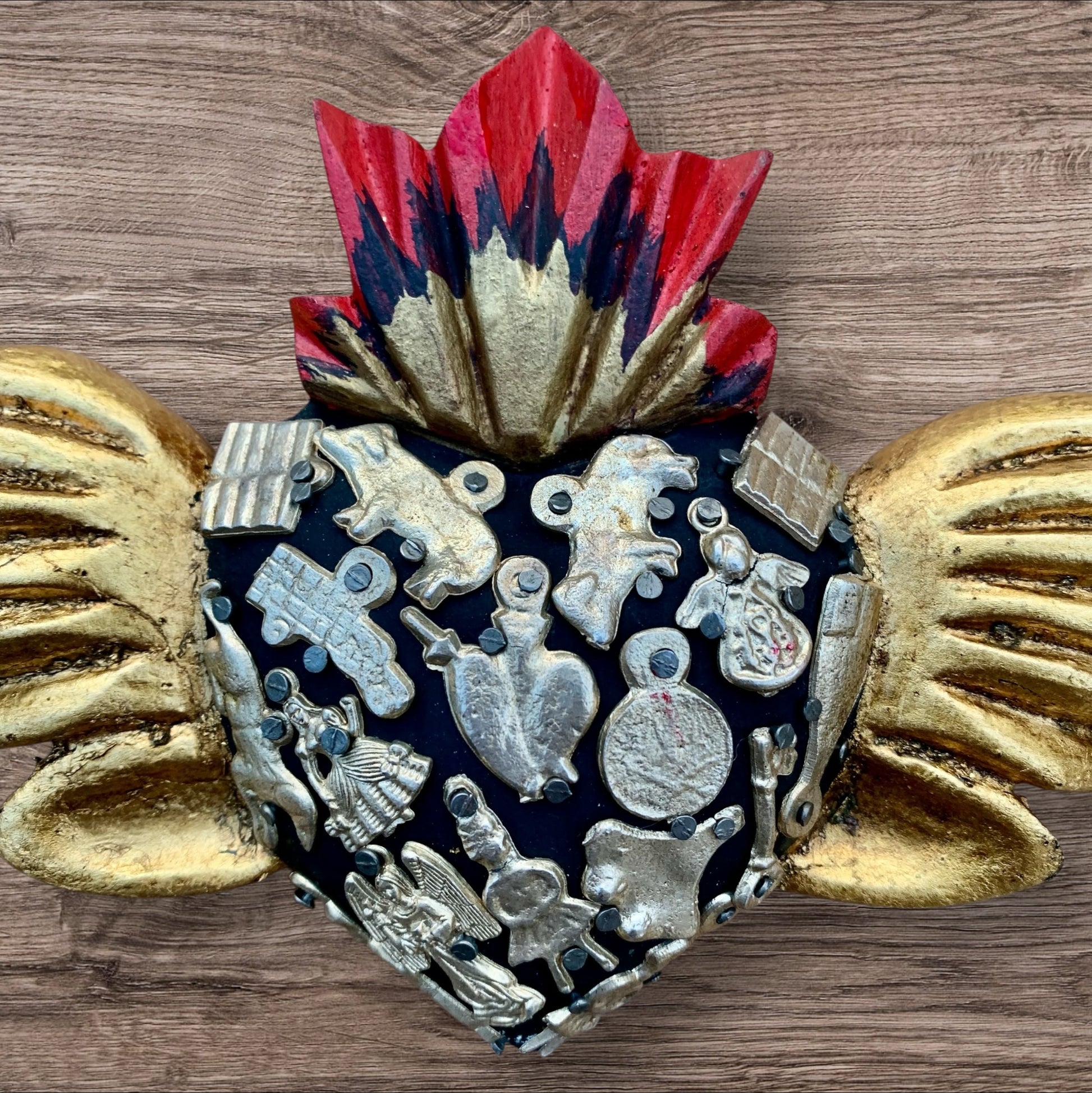 Milagros decorated flying sacred heart center
