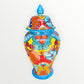 Colorful Mexican Talavera ceramic jar with lid decorated with intricate multicolor traditional patterns Other side