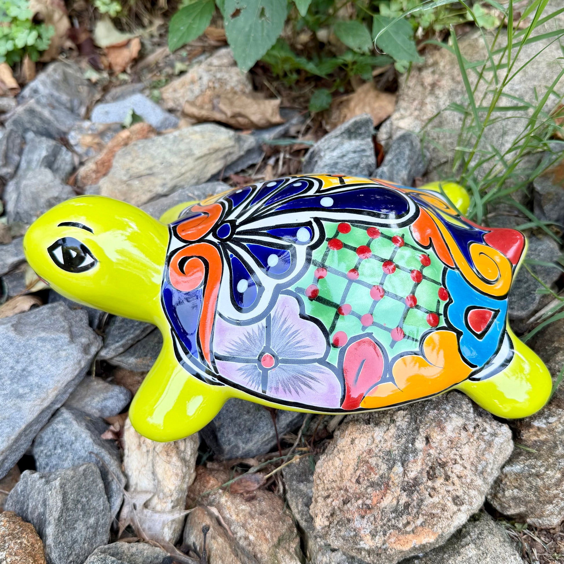 Mexican Talavera Colorful turtle-shaped object on a rocky surface Right side