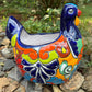 Colorful Mexican Talavera ceramic chicken shape planter on a natural background