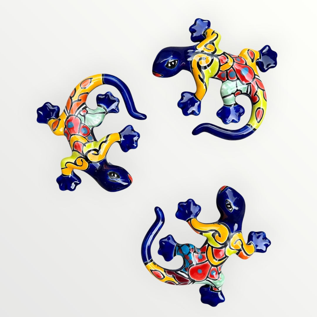 Three colorful ceramic lizards on a white background