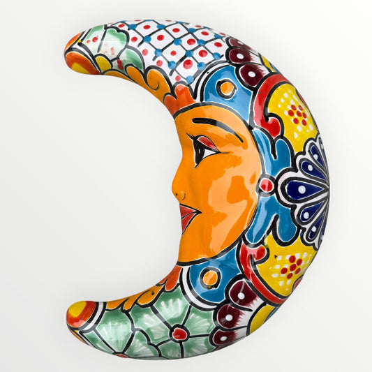 Decorative ceramic moon with colorful patterns on a white background side view