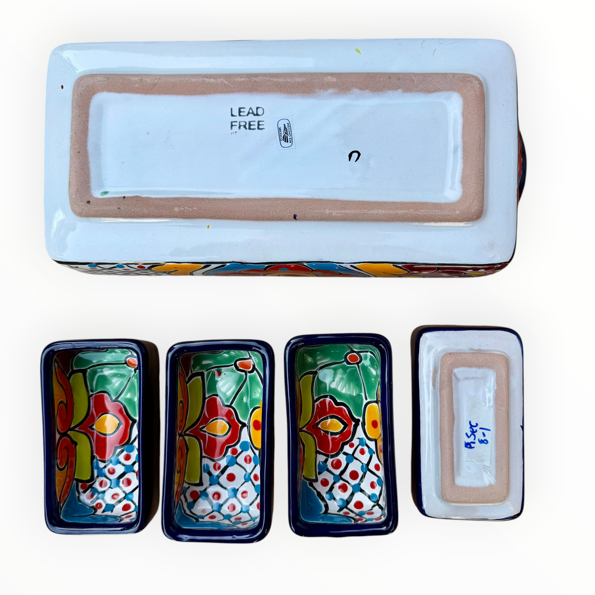 A sectional, rectangle Talavera hand-painted serving fish with a deep rectangular dish and four shallow rectangular sections, decorated with vibrant floral and geometric patterns in blue, red, green, yellow, and orange. This is the bottom view.