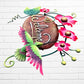 Decorative 'Welcome' sign with pink flowers and a hummingbird on a white brick wall background right side view