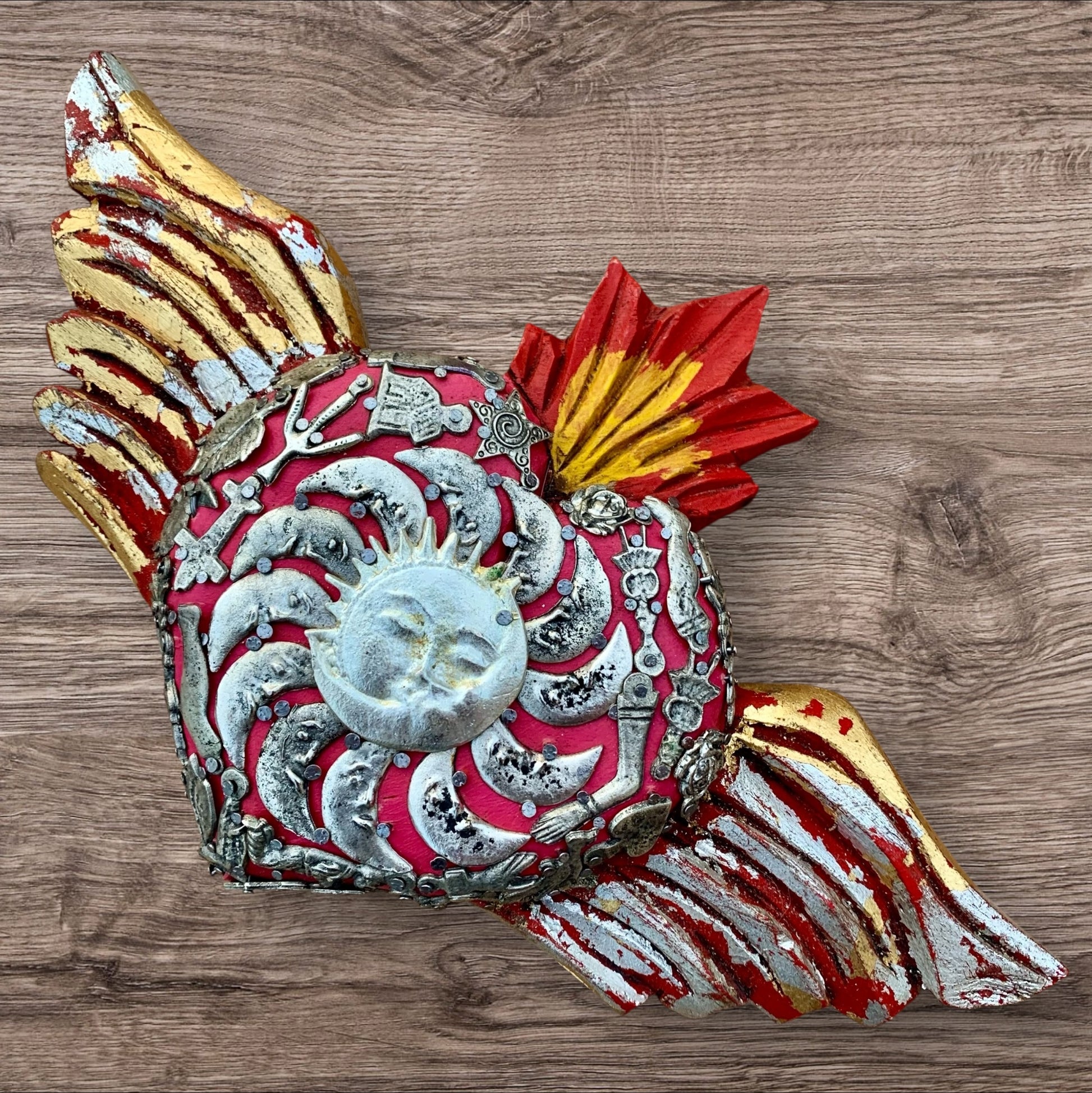 Rustic Milagros Winged Sacred Heart 
With a sun and moon in heart center.