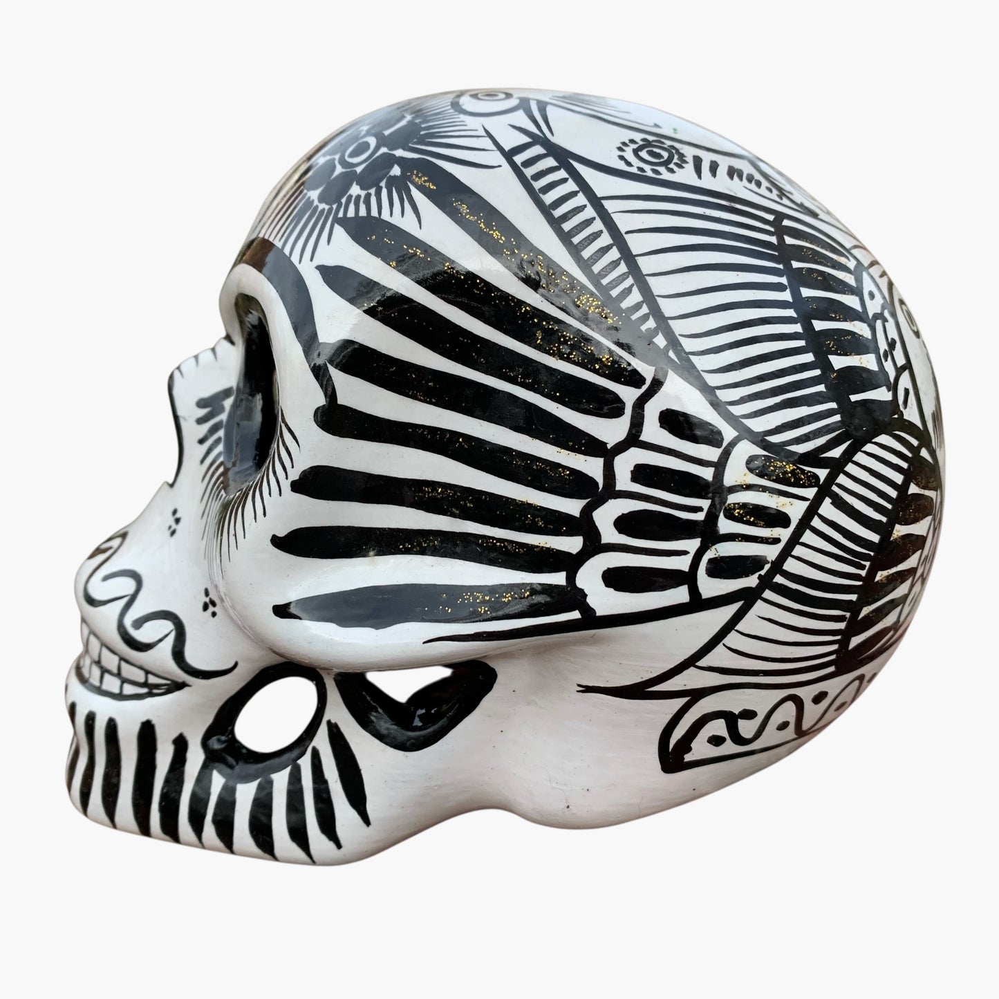 Black and white Mexican Sugar skull with vibrant designs on a white background