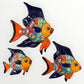 Three colorful fish-shaped wall decorations on a white background