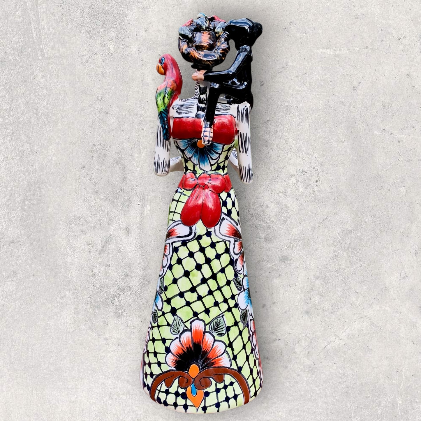 Talavera Frida doll holding parrot and monkey back view