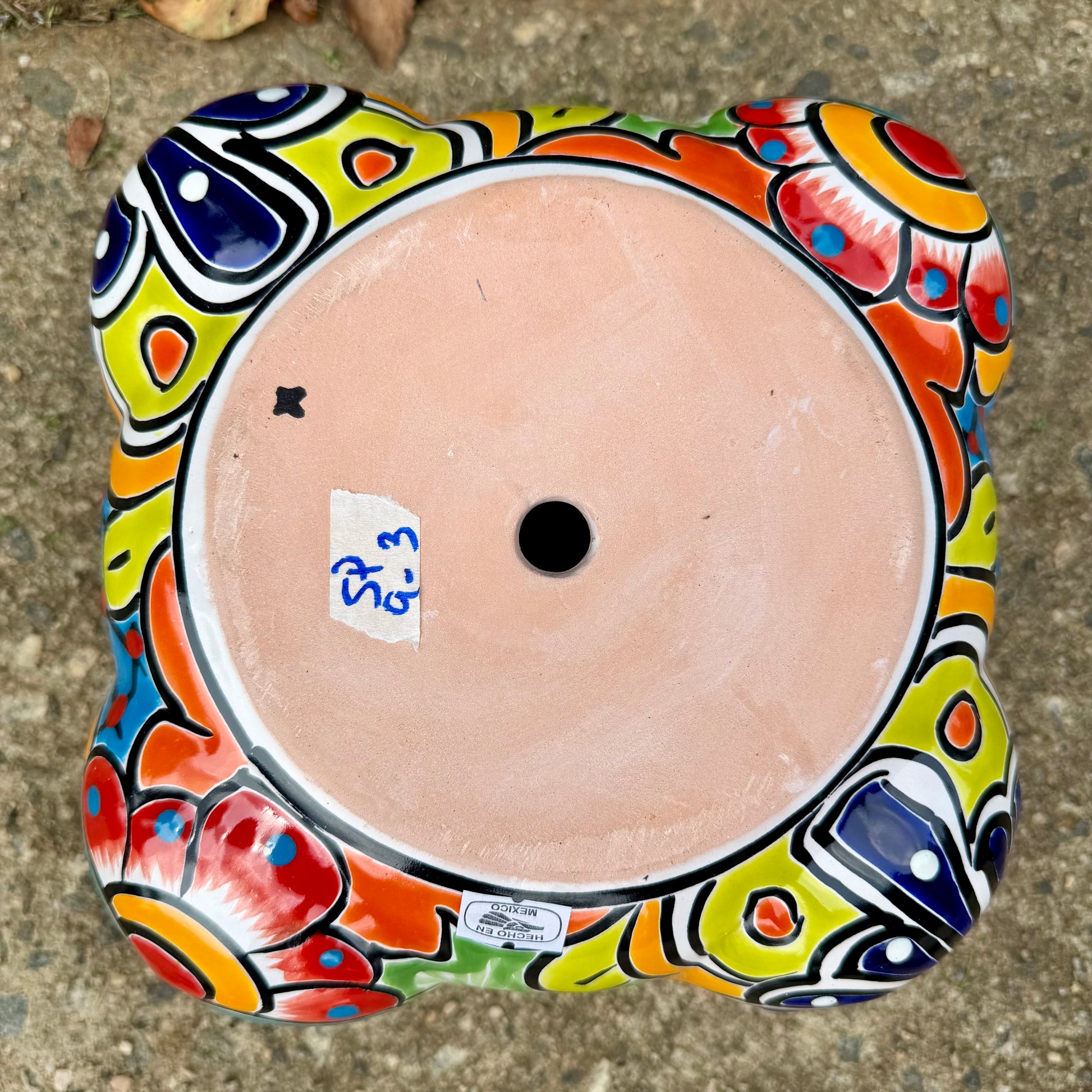 Hand painted Mexican Talavera Strawberry pot with a large top opening a four pockets on each side.  Trim color is bright red, body has multi-color designs. Photos showing bottom with drain hole.
