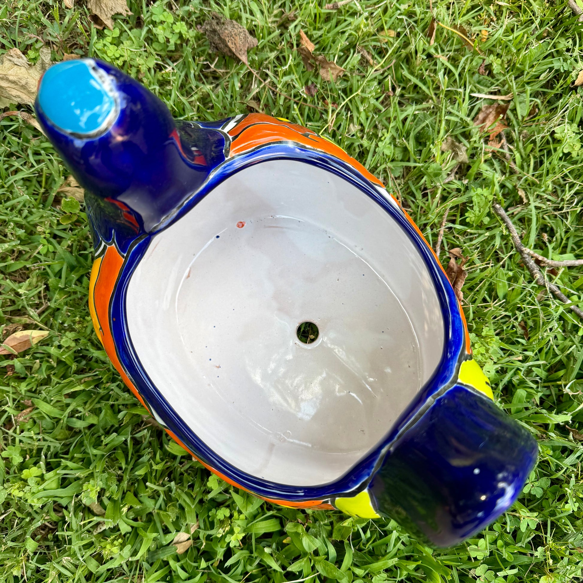 Colorful Mexican Talavera ceramic chicken shape planter on a natural background Top view