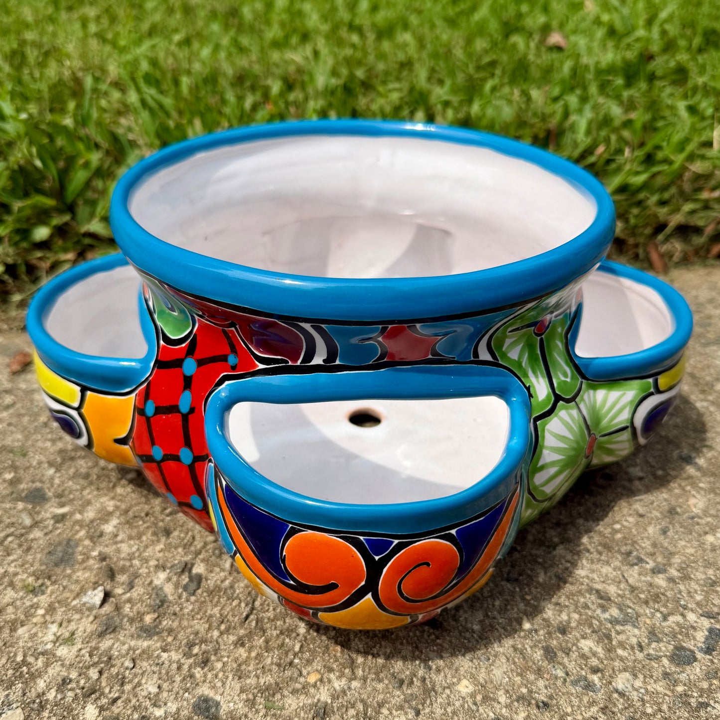 Hand painted Mexican Talavera Strawberry pot with a large top opening a four pockets on each side.  Trim color is turquoise body has multi-color designs.