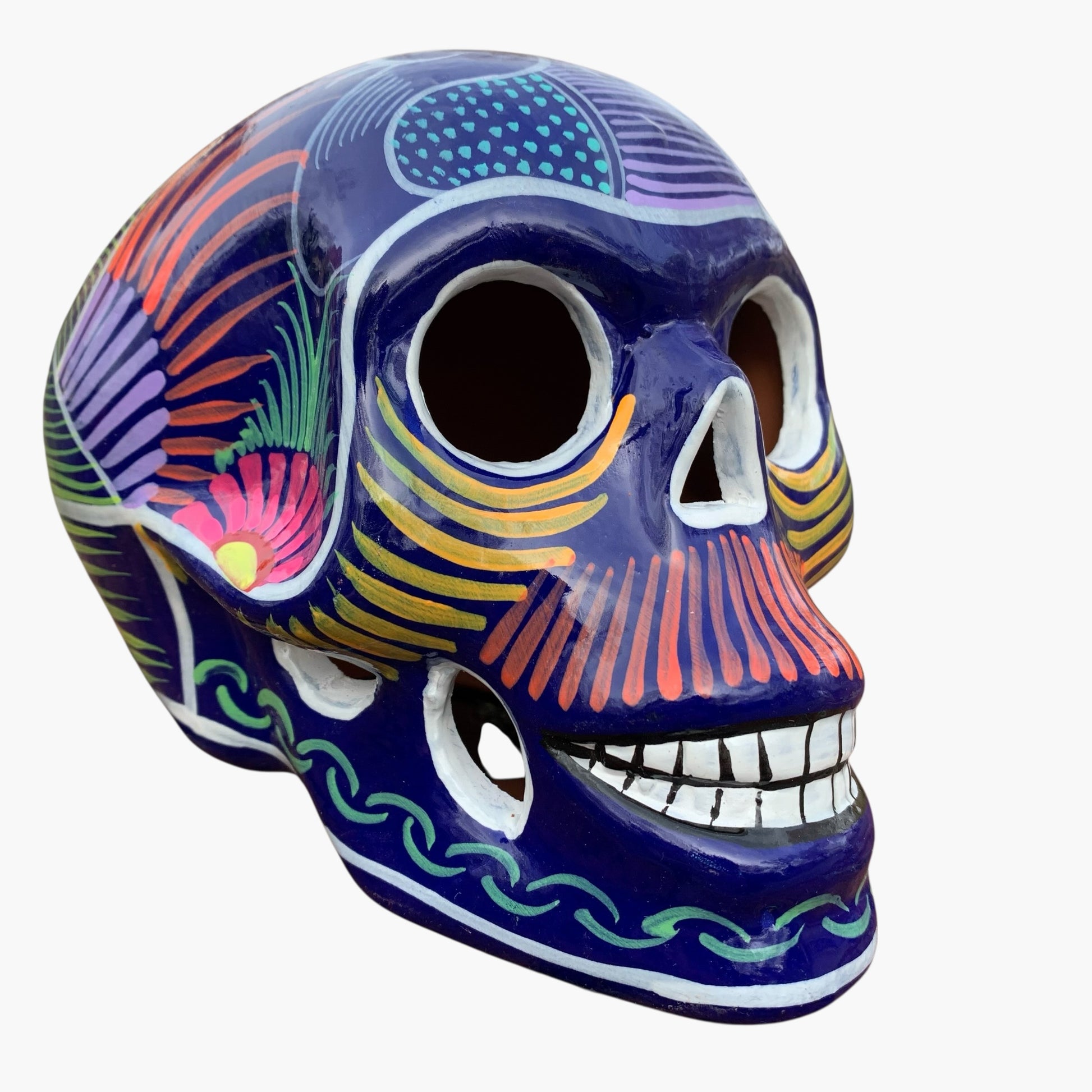 Colorful Mexican Sugar skull purple with vibrant designs on a white background