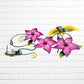Decorative wall art with purple flowers and colorful hummingbirds on a white brick background side view