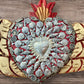 Winged Milagros sacred heart with center heart charm surrounded by sea shells Center charm close up