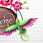 Decorative 'Welcome' sign with pink flowers and a hummingbird on a white brick wall background bird close up.