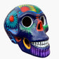 Colorful Mexican Sugar skull purple with vibrant designs on a white background