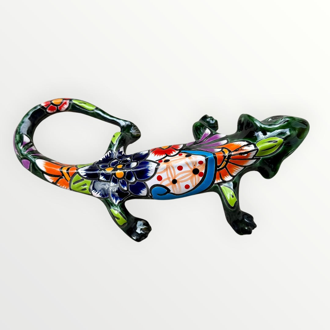 Mexican Talavera wall mounted iguana in dark green with multicolor designs left side view.