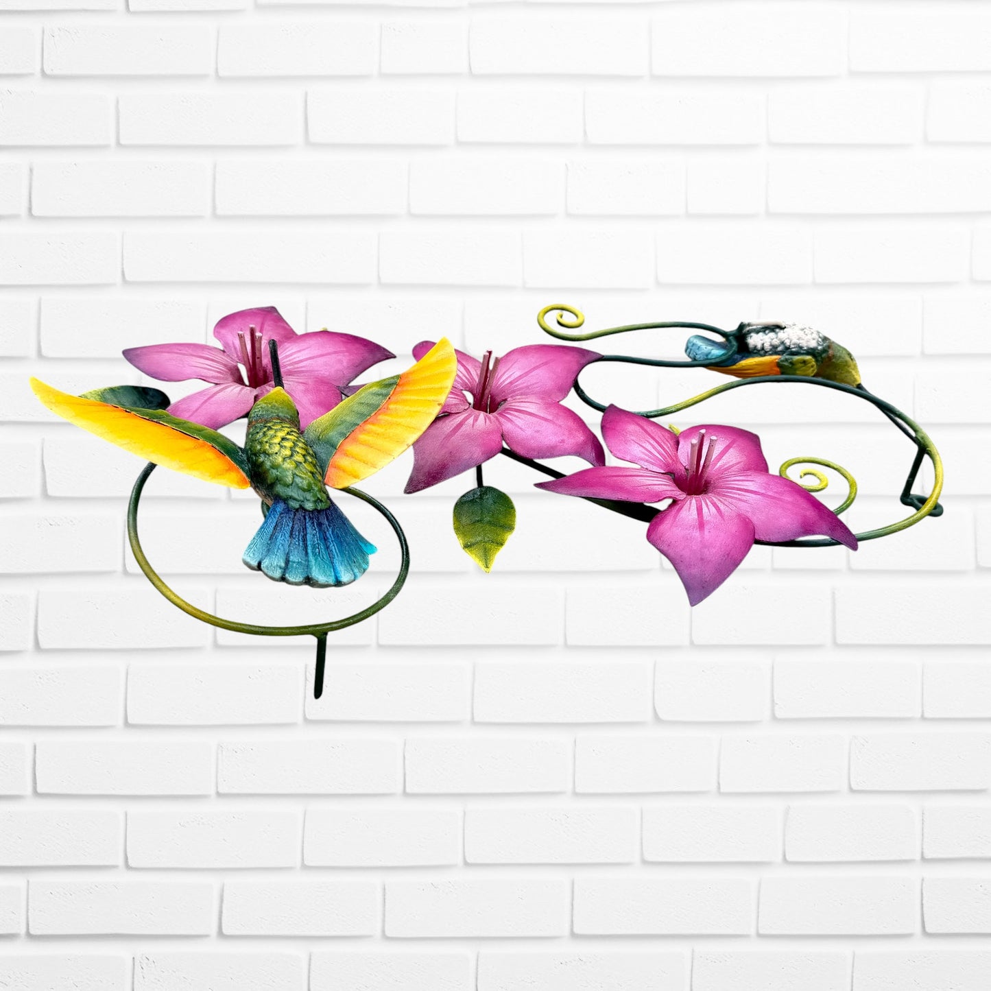 Decorative wall art with purple flowers and colorful hummingbirds on a white brick background left side view