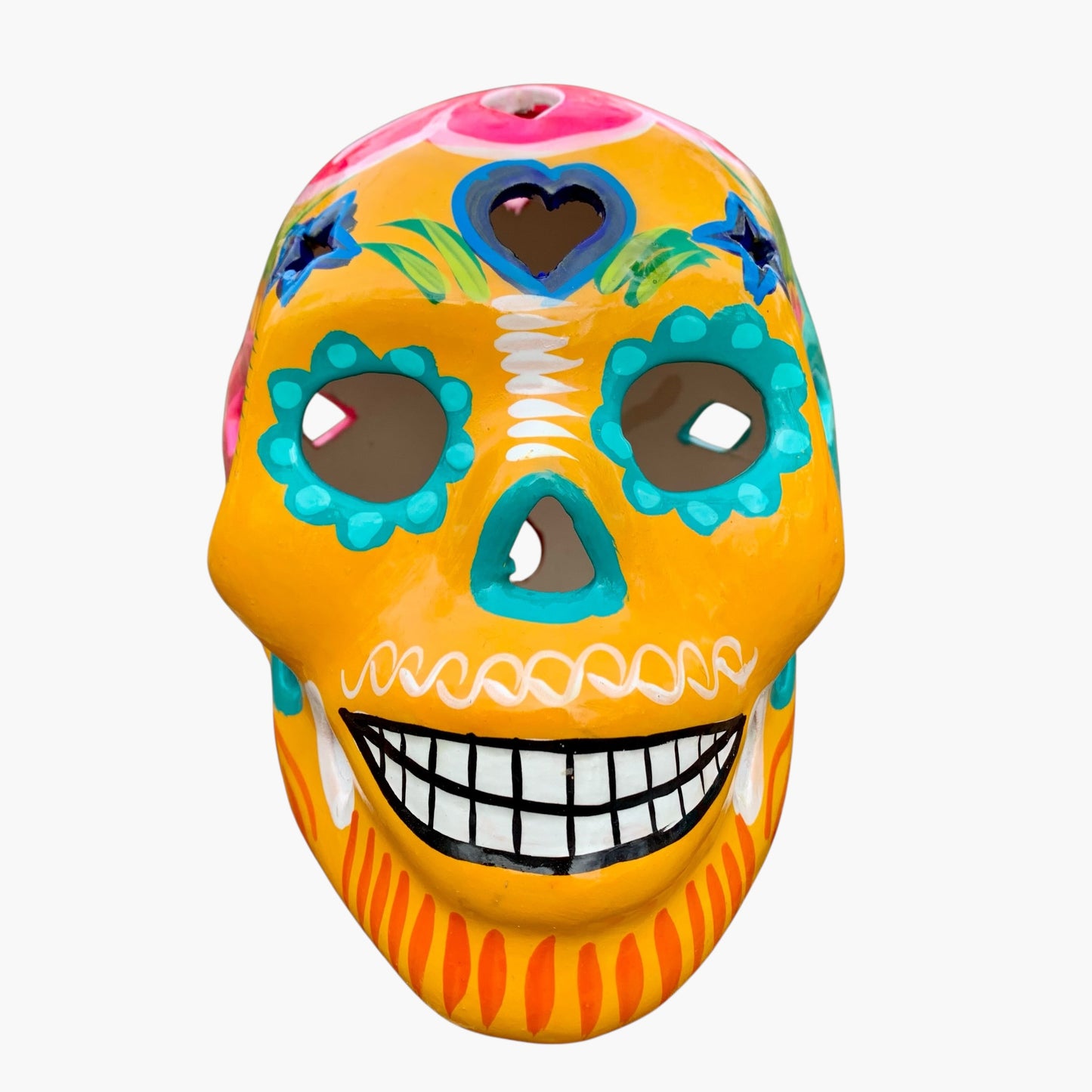 Colorful Mexican Sugar skull with yellow vibrant designs on a white background front view 