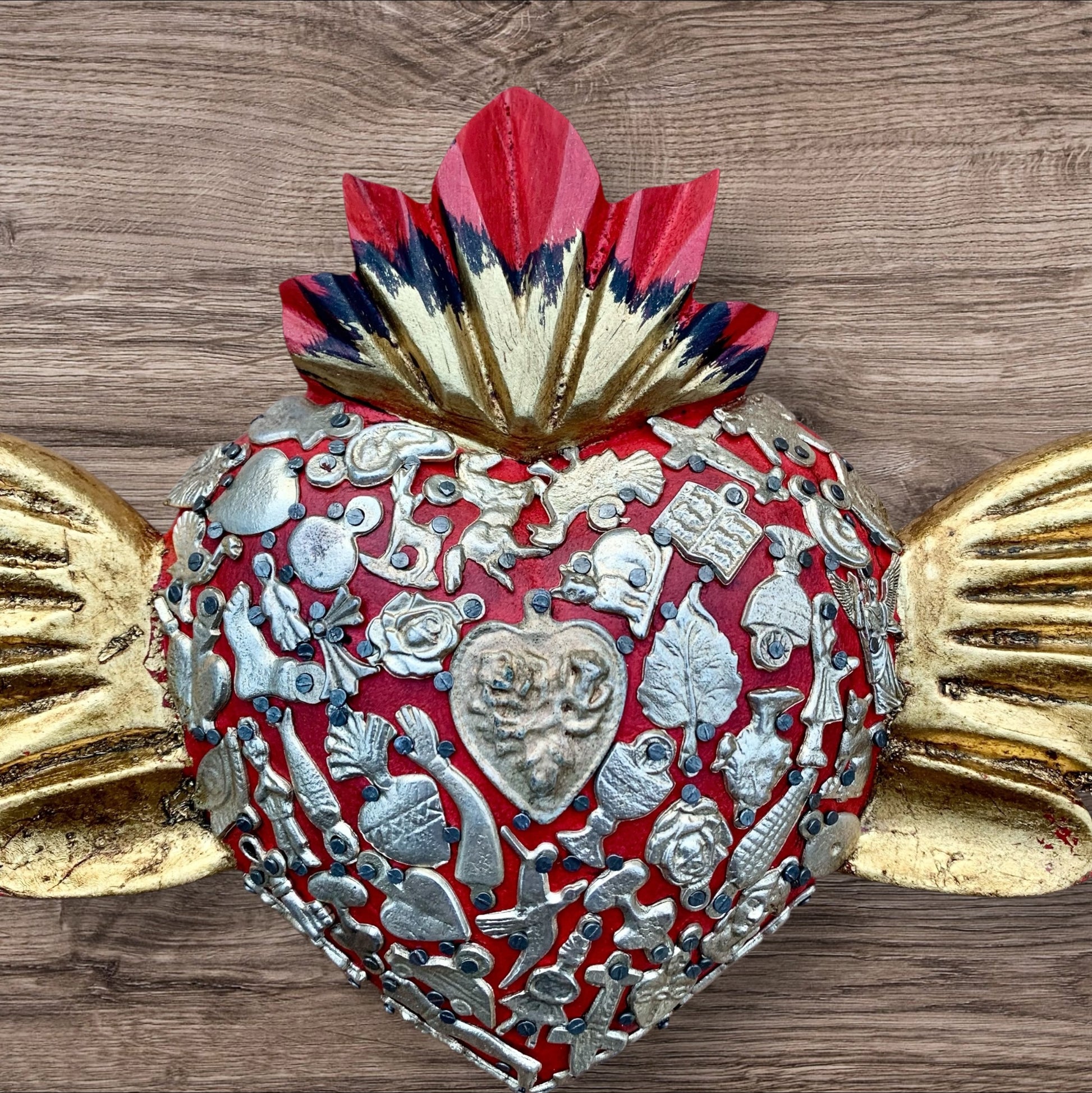 Milagros decorated sacred heart with wings center