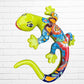 A colorful decorative lizard Talavera wall sculpture with a hand-painted floral and geometric pattern, mounted against a white brick wall, left side view.