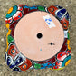 Hand painted Mexican Talavera Strawberry pot with a large top opening a four pockets on each side.  Trim color is cherry red, body has multi-color designs on each side. Photo shows drain hole on the bottom.