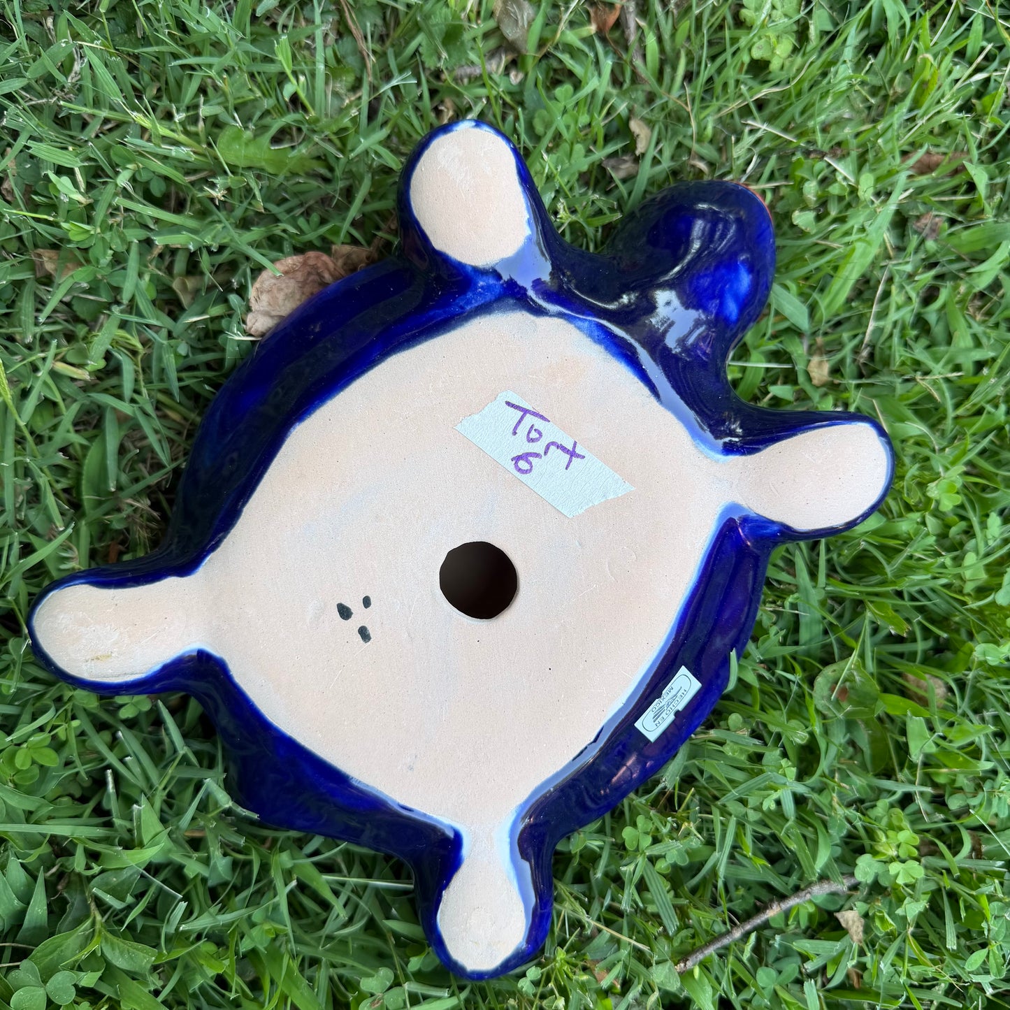 Colorful Mexican Talavera ceramic turtle figurine on a natural stone background Bottom