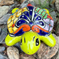 Mexican Talavera Colorful turtle-shaped object on a rocky surface Front