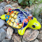 Mexican Talavera Colorful turtle-shaped object on a rocky surface