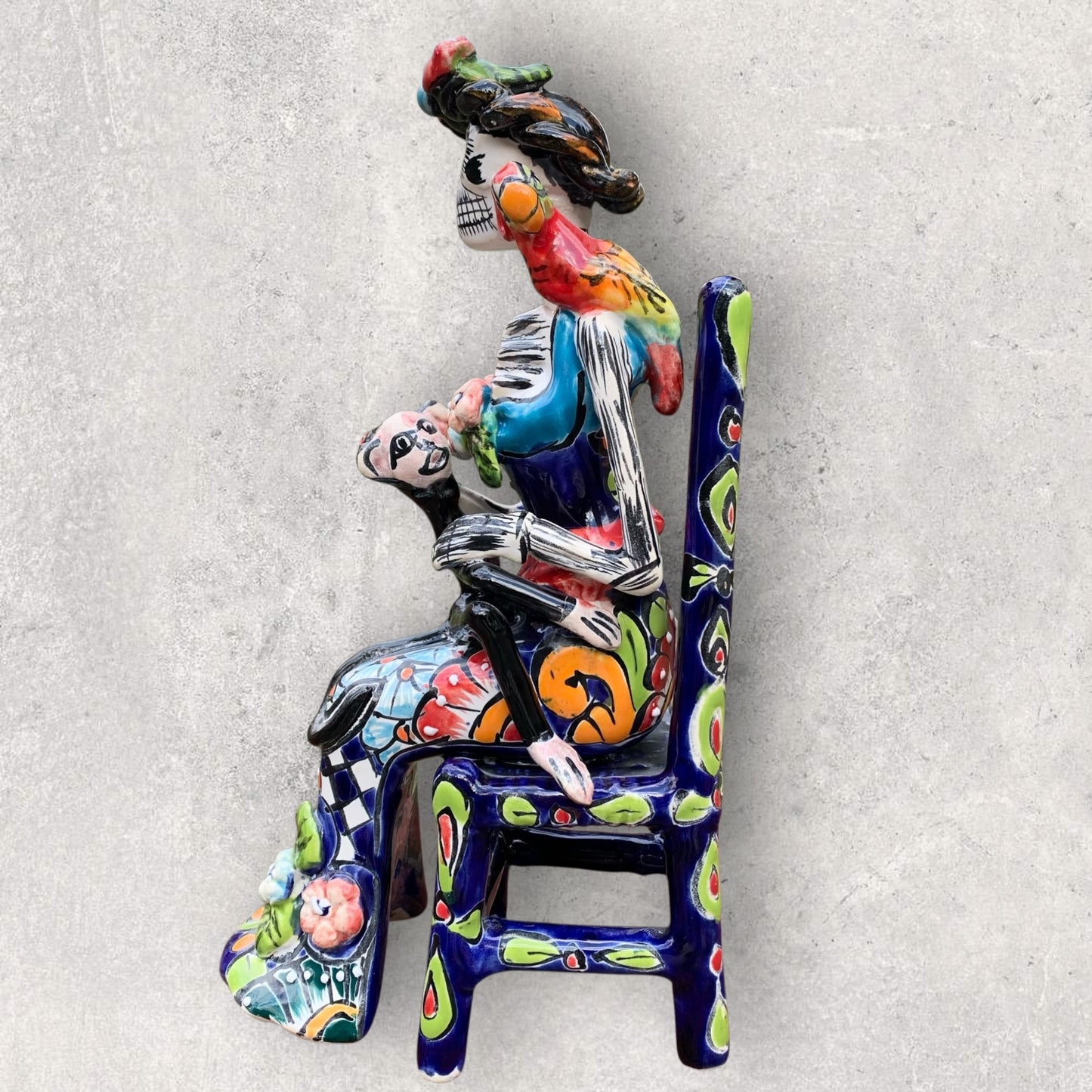 Frida Senada Side view of Frida sitting in a chair with animal friends 