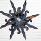 A whimsical sun wall sculpture with big blue eyes, a smiling face, and vibrant, back of sun showing hanging loop. 