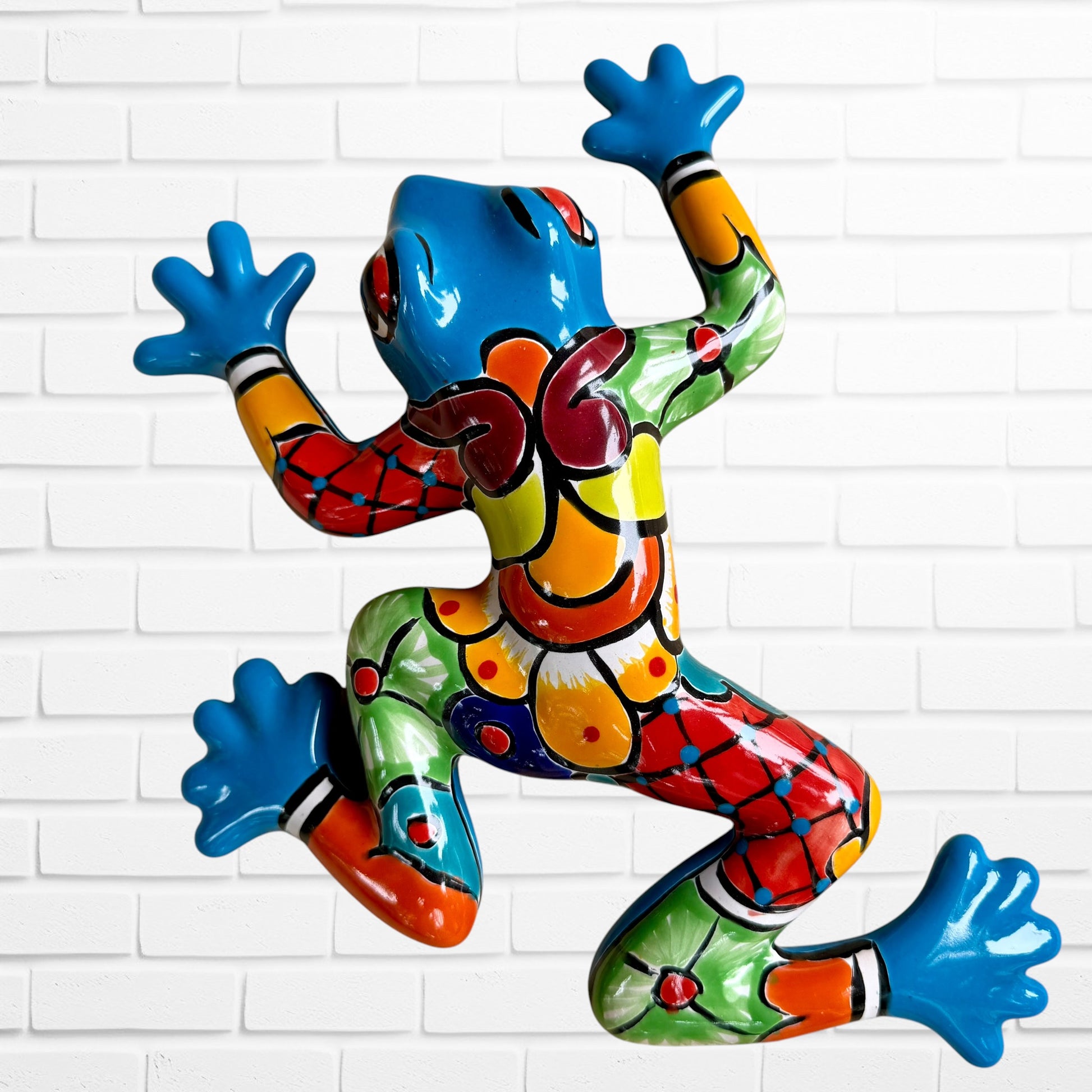 Mexican Talavera wall, frog, and turquoise with multicolored designs.