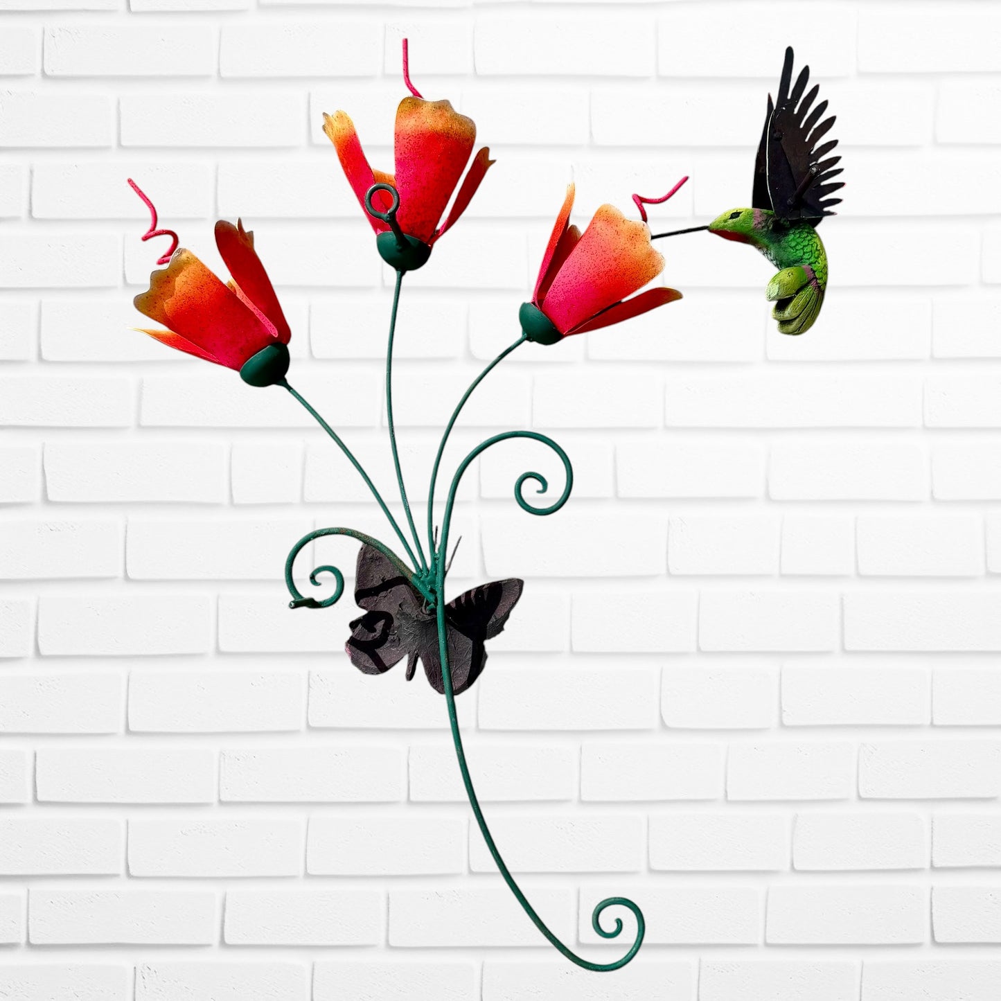 Decorative wall art with orange flowers, hummingbird, and a butterfly on a white brick wall background back view