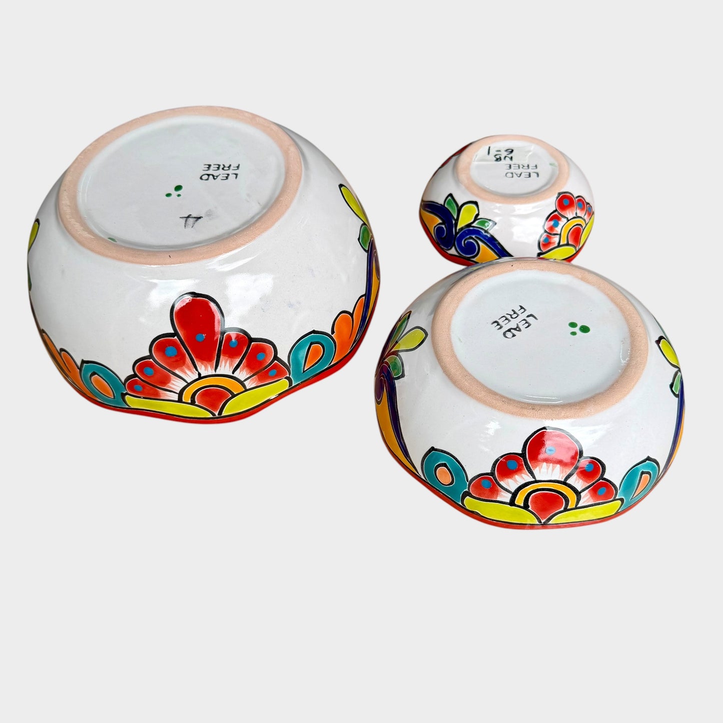 Three colorful talavera nesting bowls with intricate patterns Side view