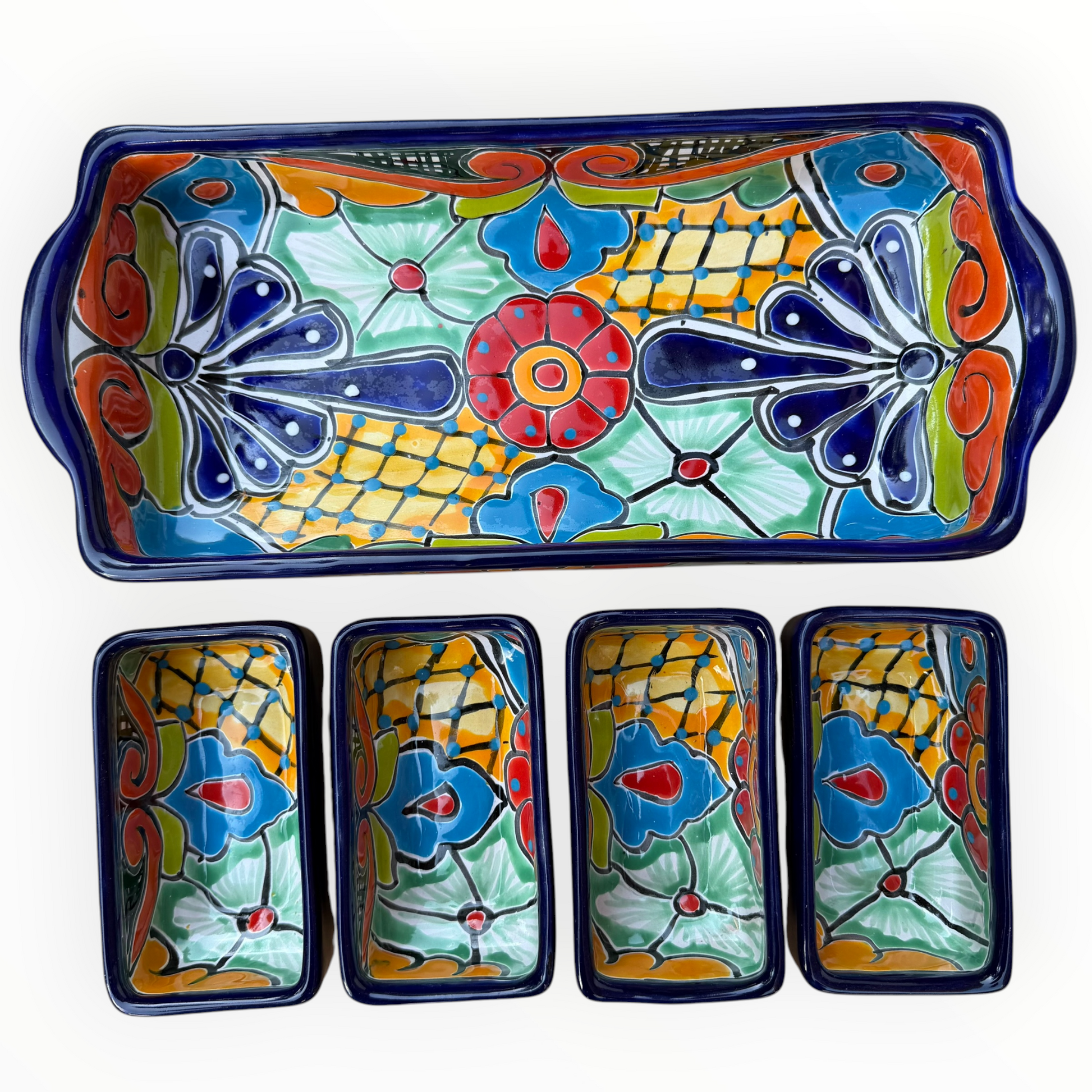 A red ceramic four-compartment serving tray with hand-painted talavera designs in blue, orange, green, and yellow on a white background, top view with sections.