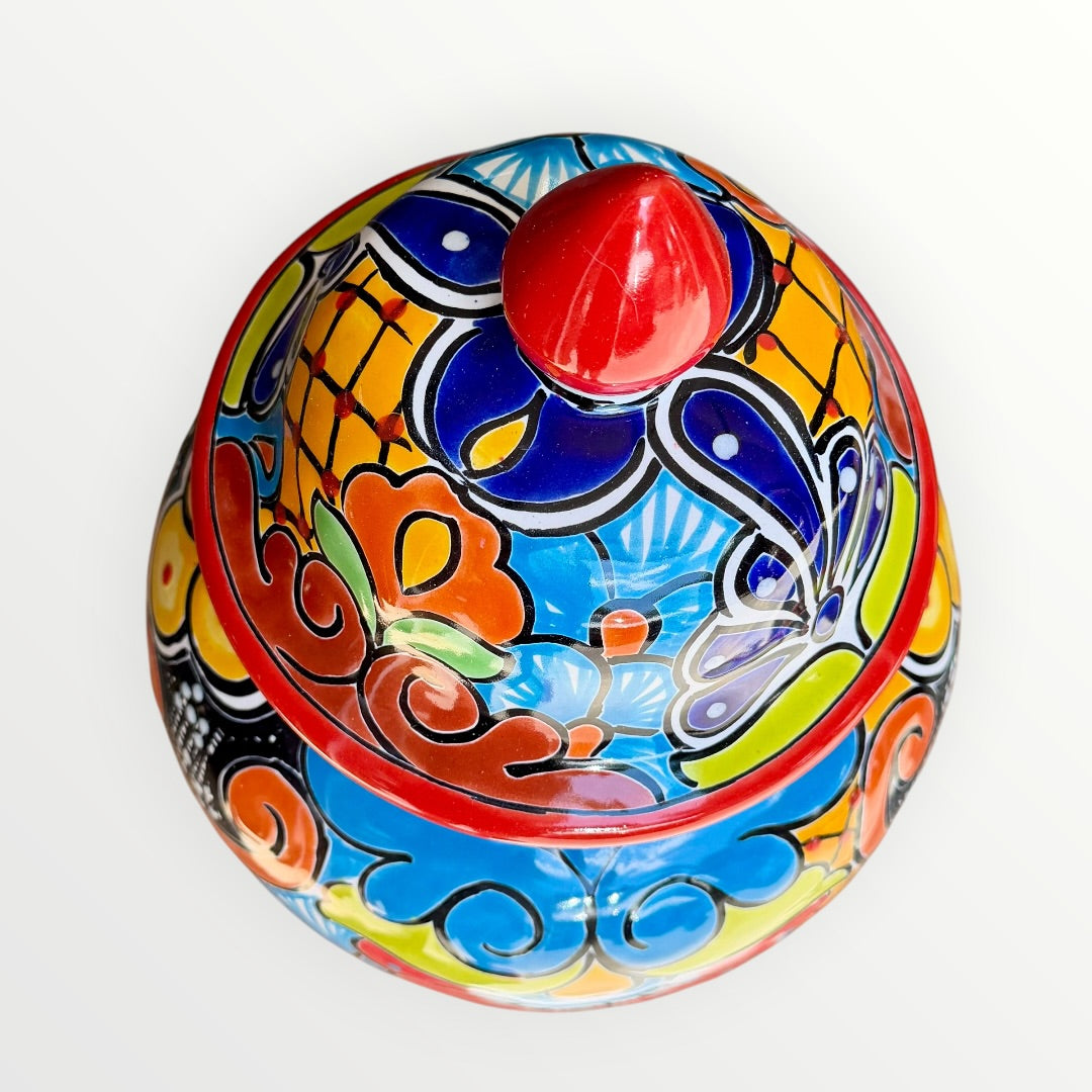 Colorful Mexican Talavera ceramic jar with lid decorated with intricate multicolor traditional patterns To view