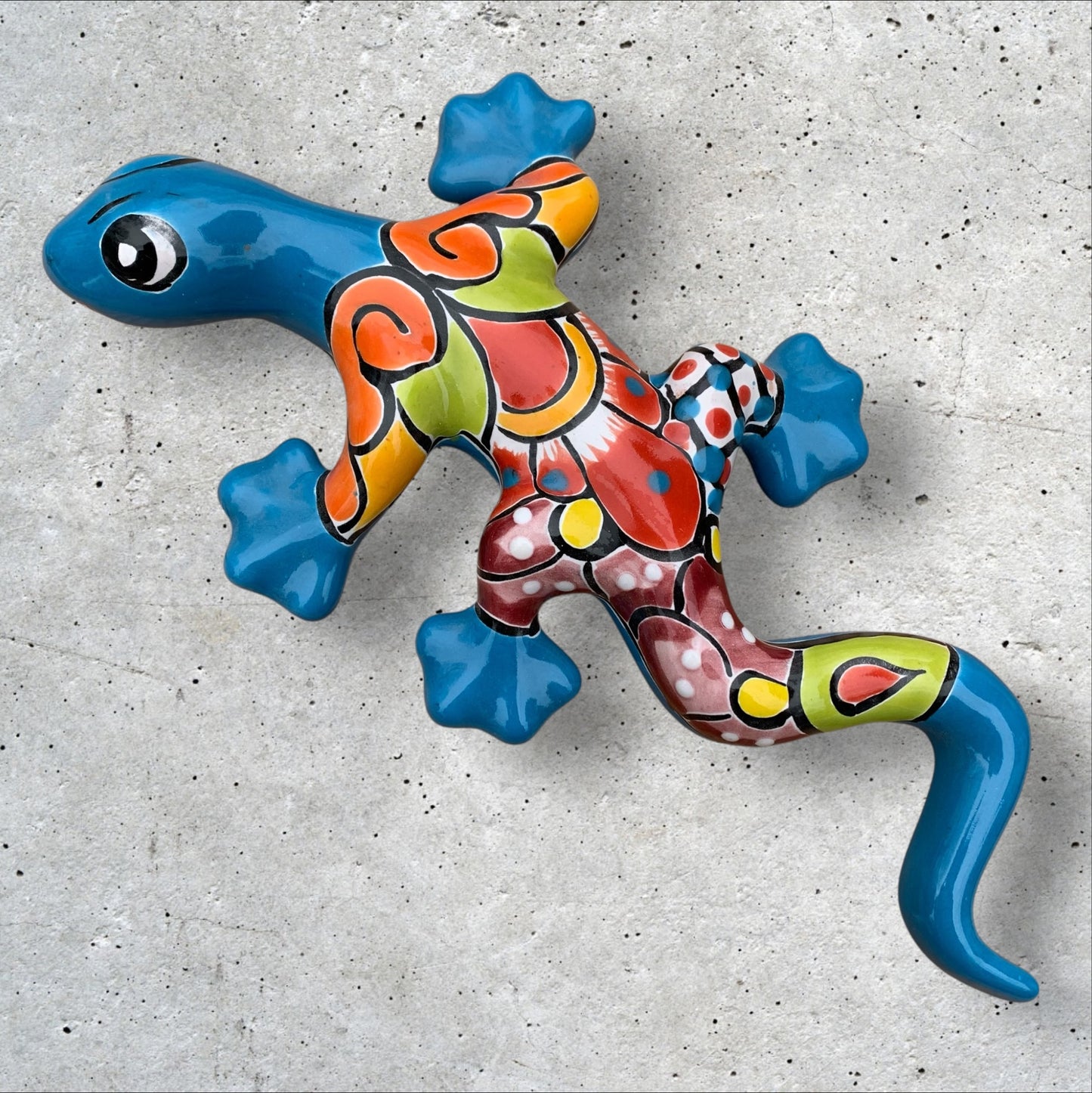 Colorful Mexican Talavera Liizard wall art on a concrete surface Turquoise Gecko Two