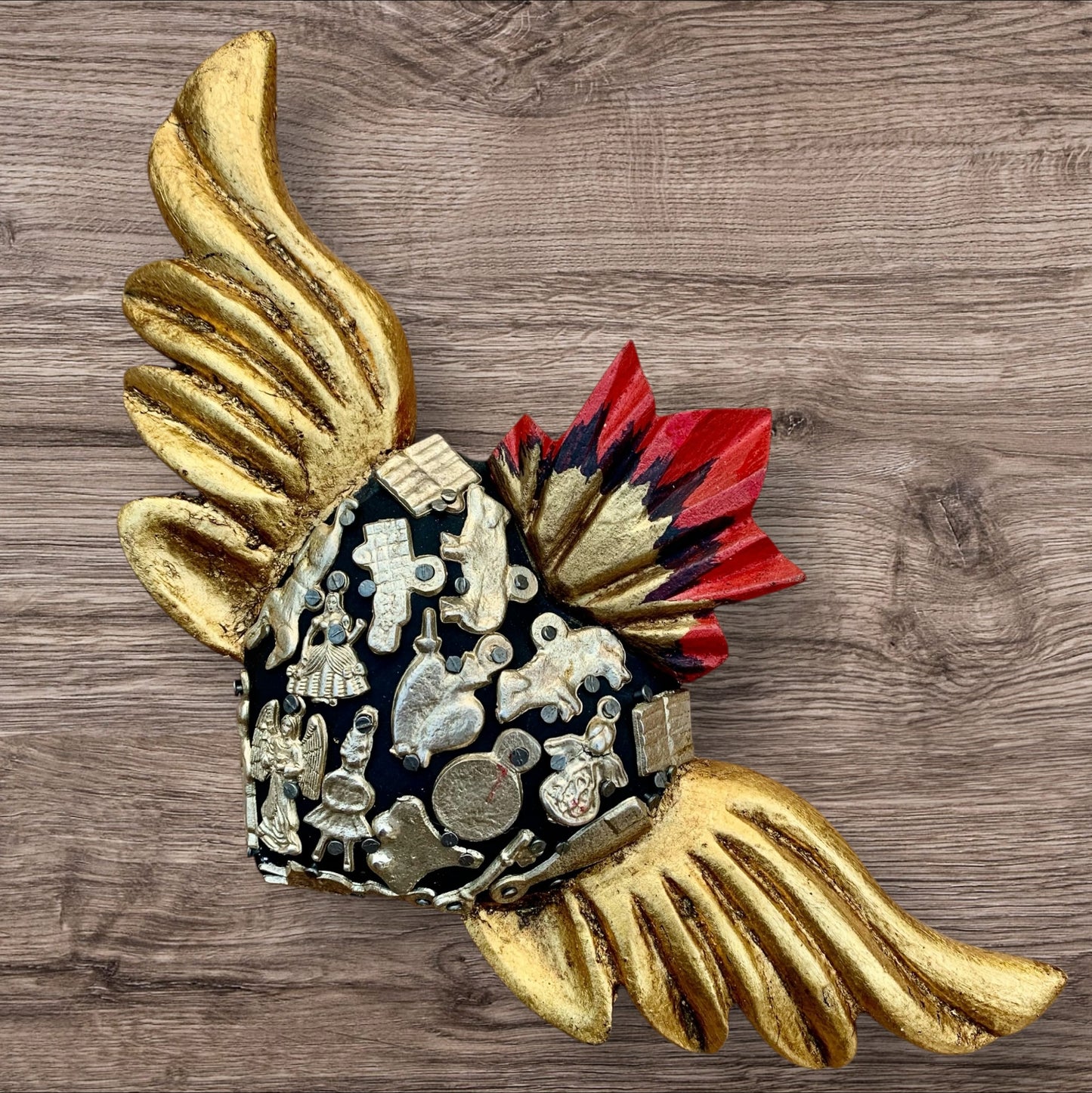 Milagros decorated flying sacred heart