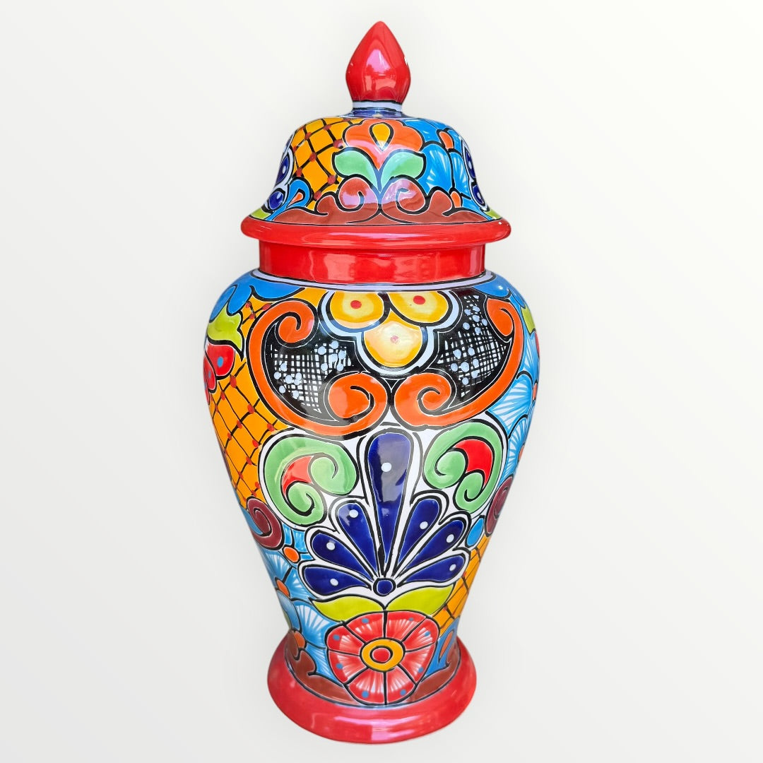 Colorful Mexican Talavera ceramic jar with lid decorated with intricate multicolor traditional patterns 