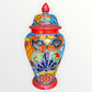 Colorful Mexican Talavera ceramic jar with lid decorated with intricate multicolor traditional patterns 