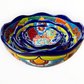 A set of three nested Talavera ceramic bowls with a vibrant hand-painted floral and geometric pattern in multiple colors, featuring a deep blue rim, shown on a plain white background, side view.