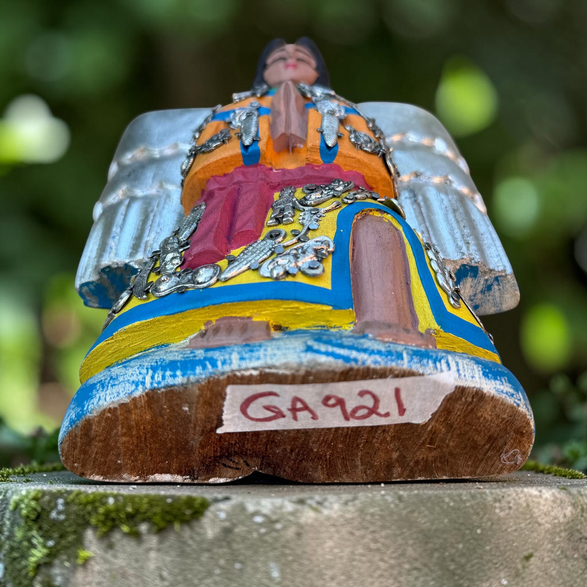 Angled view of Milagros Angel showing her charms and wings.