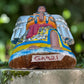 Angled view of Milagros Angel showing her charms and wings.