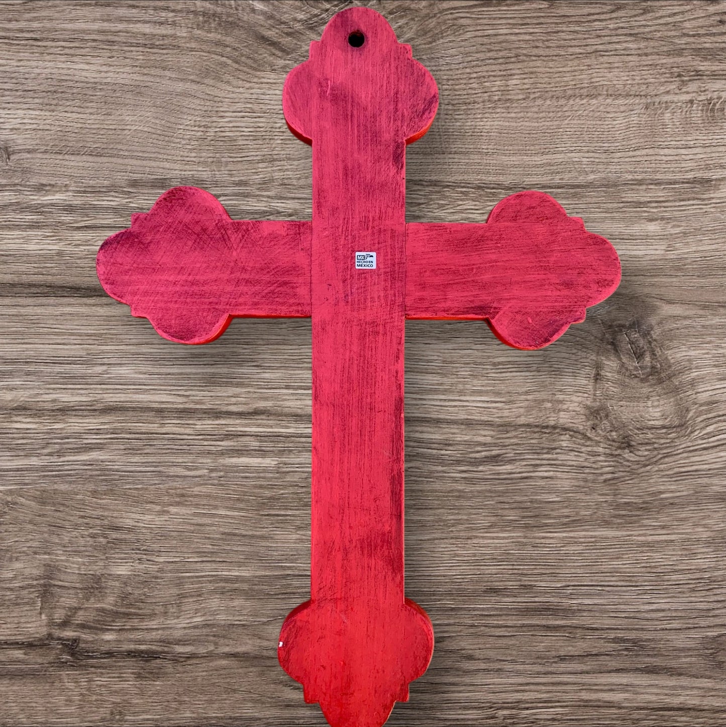 Milagros decorated wood cross back view with hanging hole
