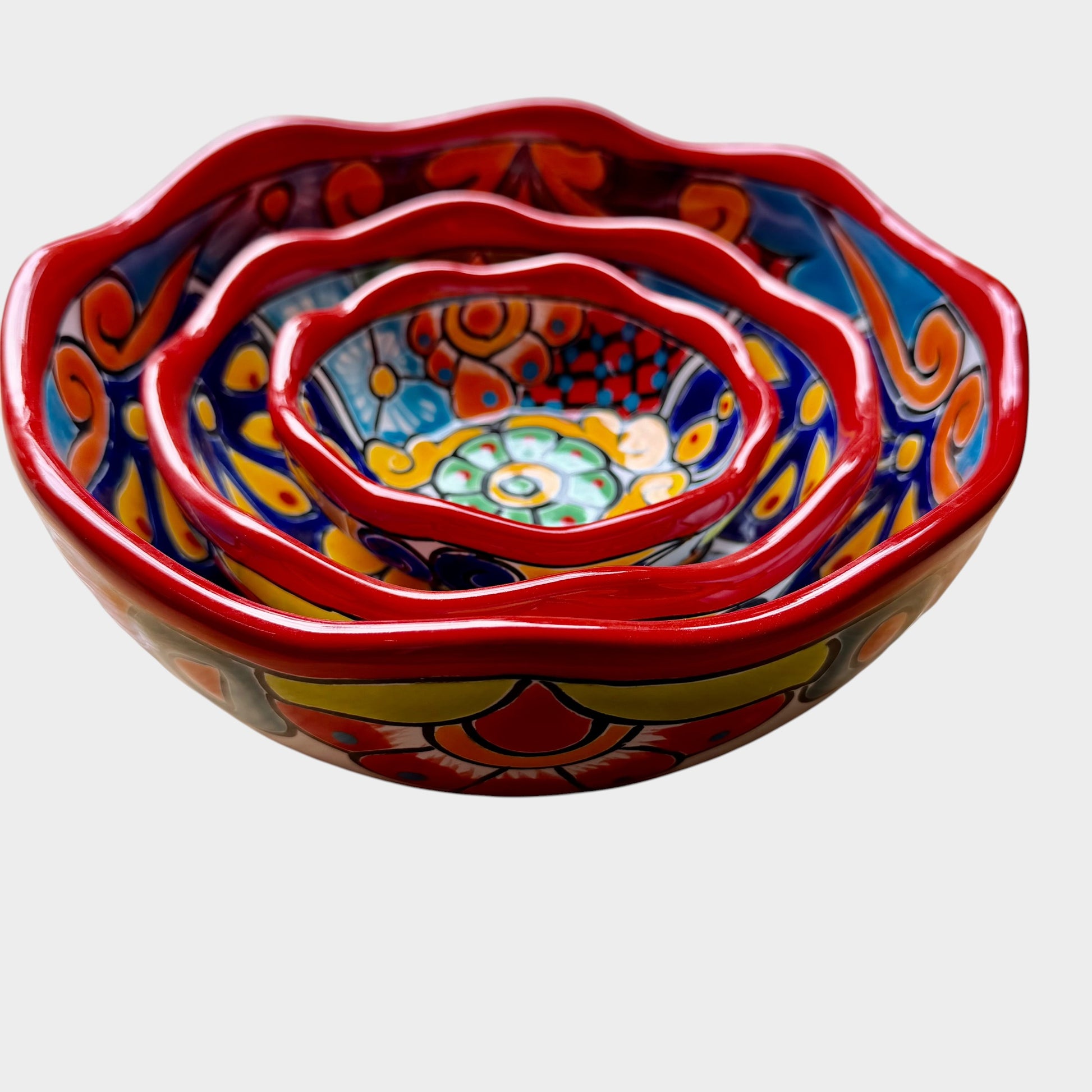 Three colorful talavera nesting bowls with intricate patterns Top view