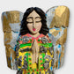 Milagro’s guardian angel figurine, close-up of face