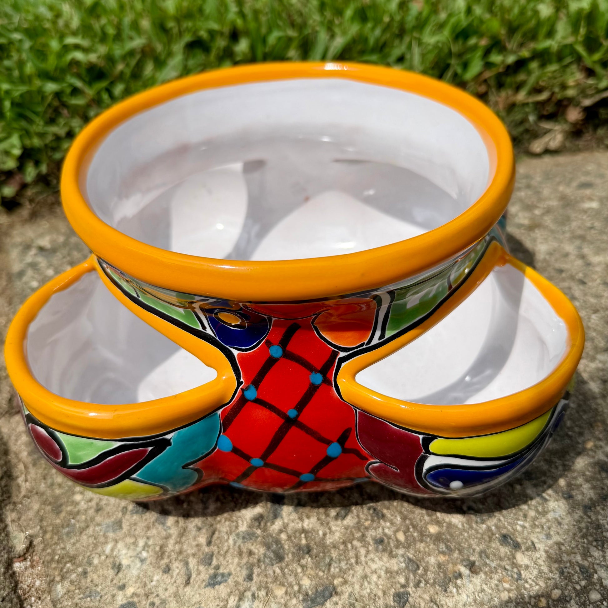Hand painted Mexican Talavera Strawberry pot with a large top opening a four pockets on each side.  Trim color is bright happy yellow, body has multi-color designs on each of the four sides. Photo of the other side.